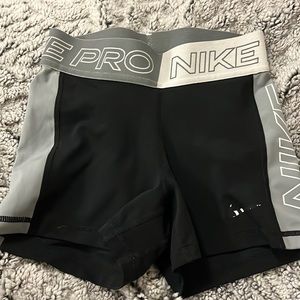 Gray, white and black Nike pros